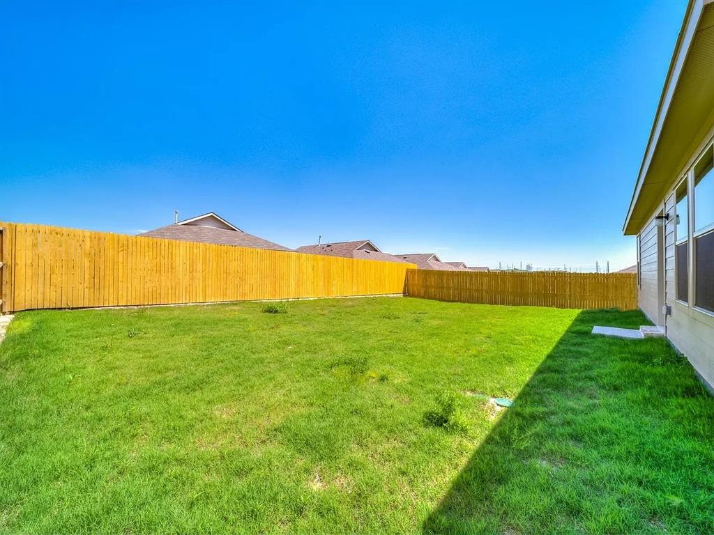 352 Sun Bluff Road Fort Worth, TX 76052 - Photo 31 of 33 Expansive grassy yard area with a wood privacy fence
