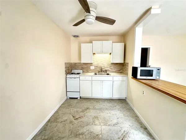 a white cabinets with wooden floor