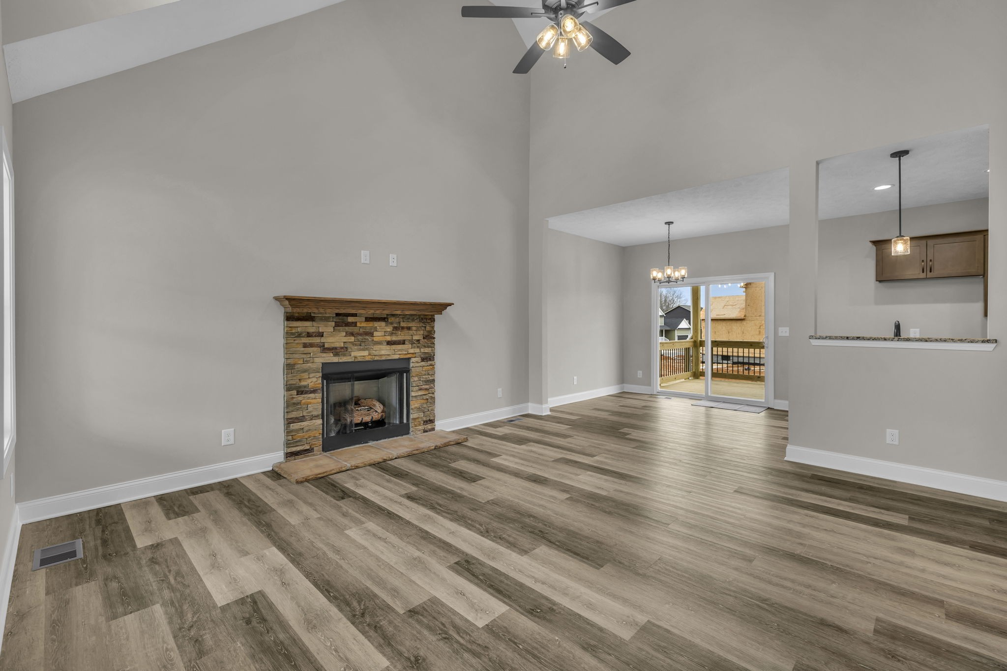 150 Cherry Fields Clarksville, TN 37042 - Photo 4 of 30 an empty room with a fireplace and chandelier fan