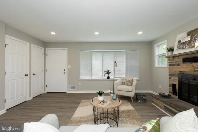 a living room with furniture and a fireplace