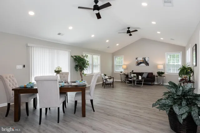 a view of a dining room with furniture window and wooden floor