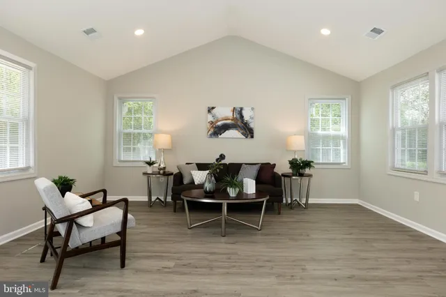 a living room with furniture a window and a dining table