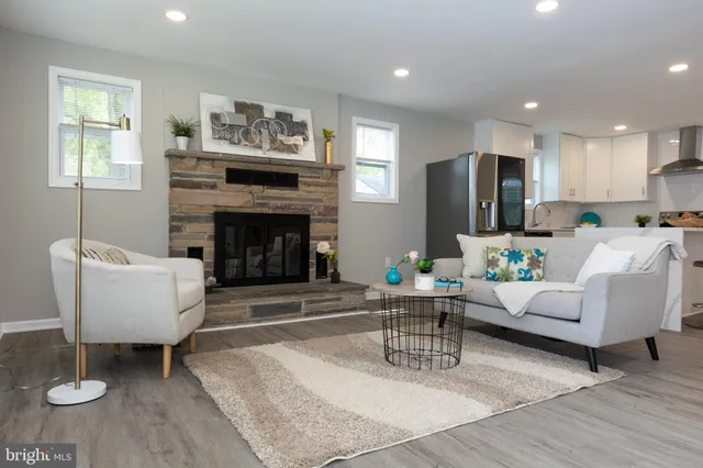 a living room with furniture a fireplace and a flat screen tv