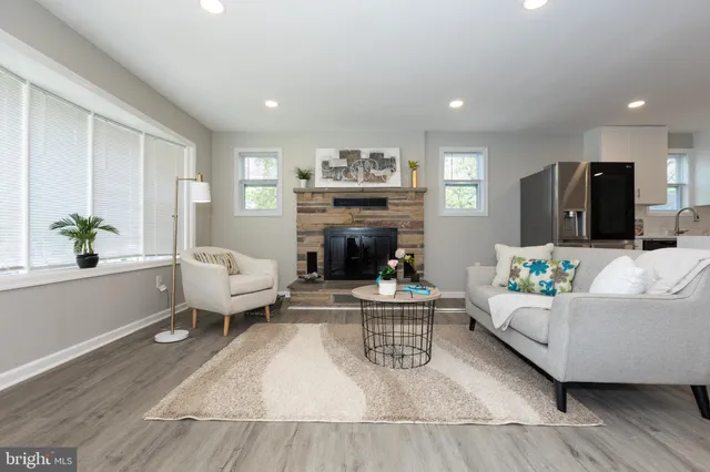 a living room with furniture and a fireplace