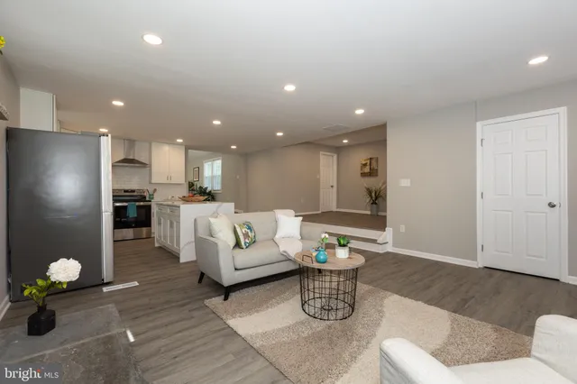 a living room with furniture and kitchen view