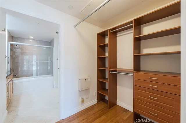 a view of walk in closet with empty racks