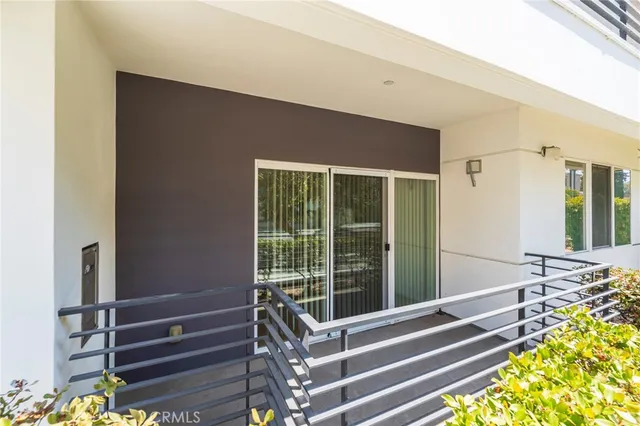 a living room with a large window and chandelier