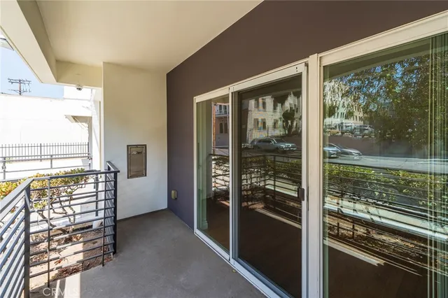 a view of open kitchen with wooden floor and outdoor space