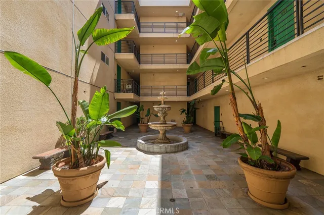 a vase of flowers sitting on a floor