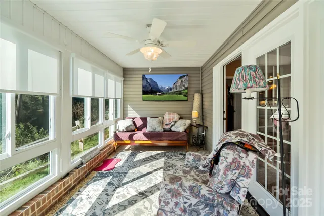 a bedroom with furniture and a large window