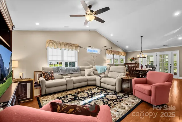a living room with furniture ceiling fan and a rug
