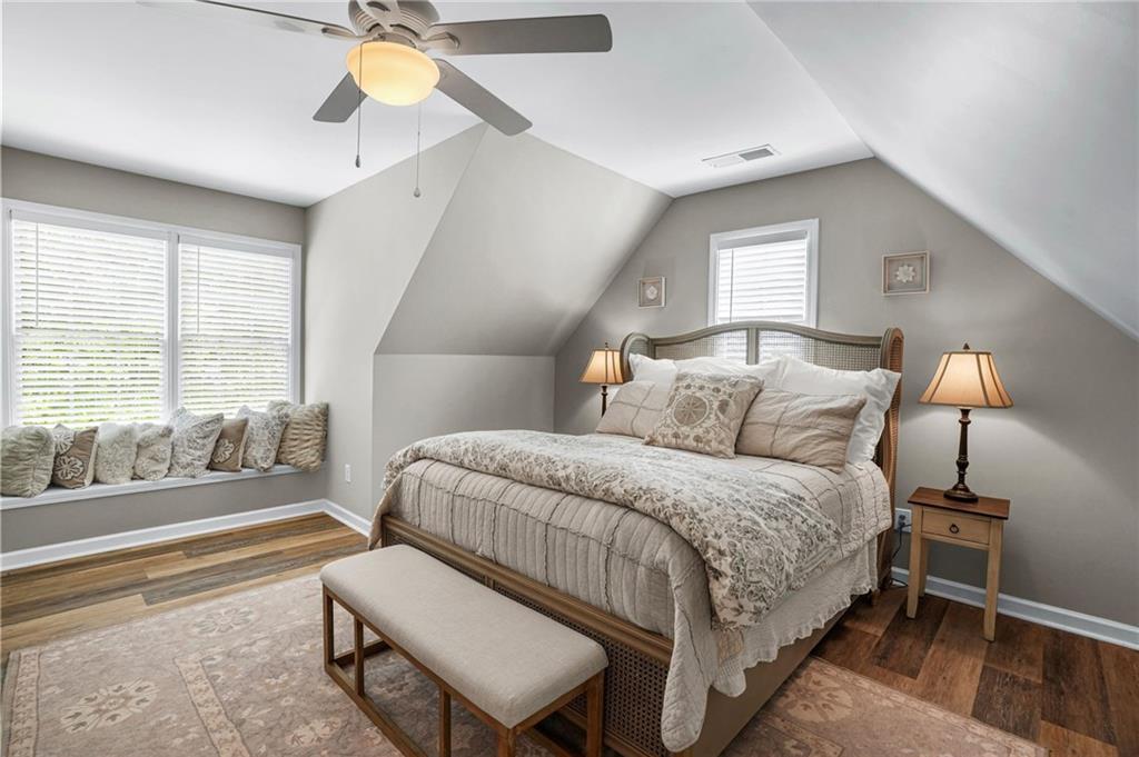 509 Crested Hawk Ridge Canton, GA 30114 - Photo 43 of 89 a bedroom with a bed and a chandelier