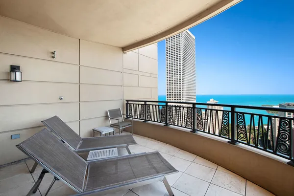 a view of a balcony with chairs