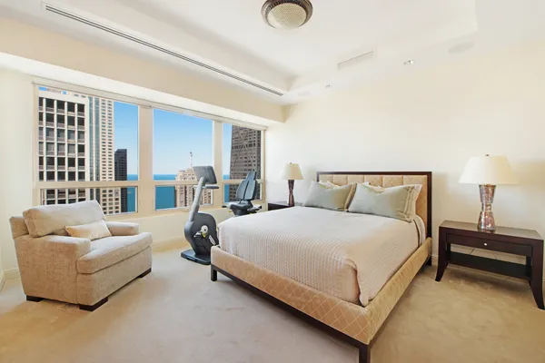 a bedroom with bed and a couch