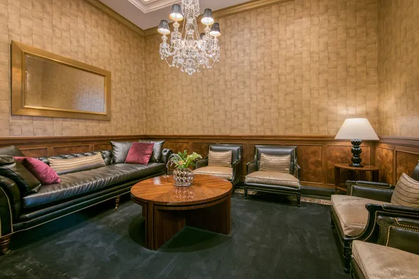 a living room with furniture and a chandelier