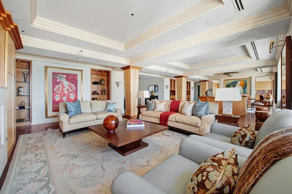 a living room with furniture ceiling fan and a rug