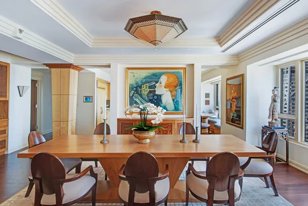 a dining room with furniture a chandelier and window