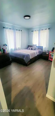 a bedroom with a bed and a table