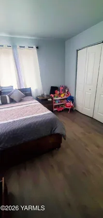 a bedroom with a bed and window