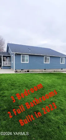 a front view of house with yard and outdoor seating