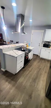 a kitchen with stainless steel appliances a stove a sink and a refrigerator