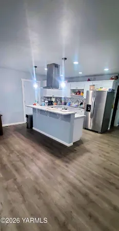 a bed room with furniture and kitchen view