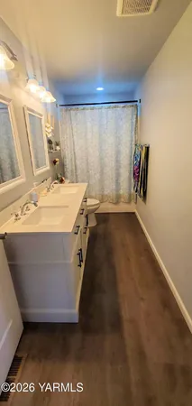 a bathroom with a toilet a sink and mirror