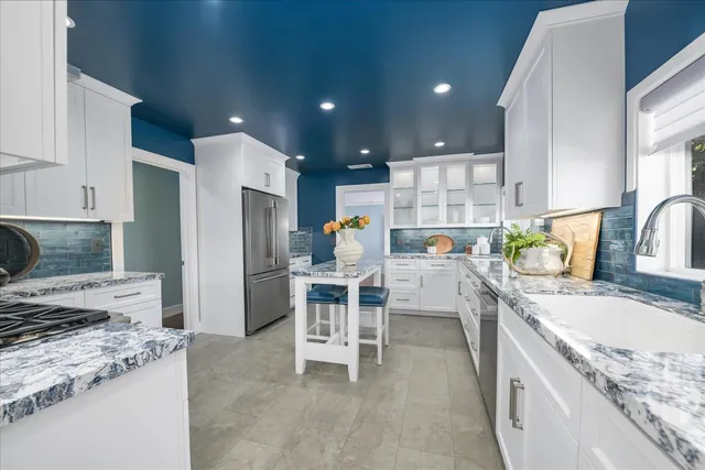 a kitchen with a sink cabinets and window