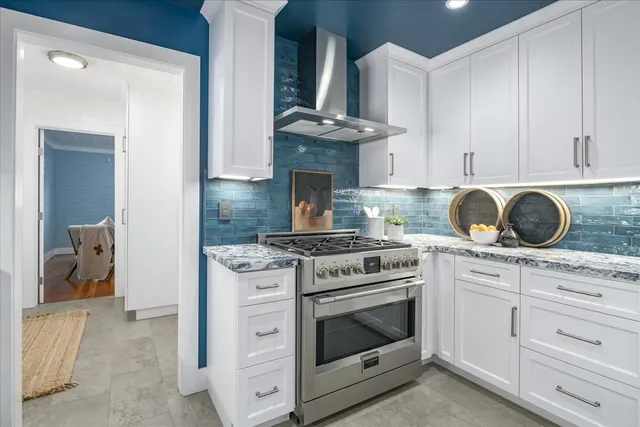 a stove top oven sitting inside of a kitchen