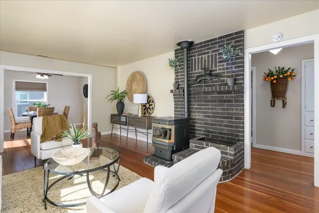 a living room with furniture a wooden floor and a chandelier