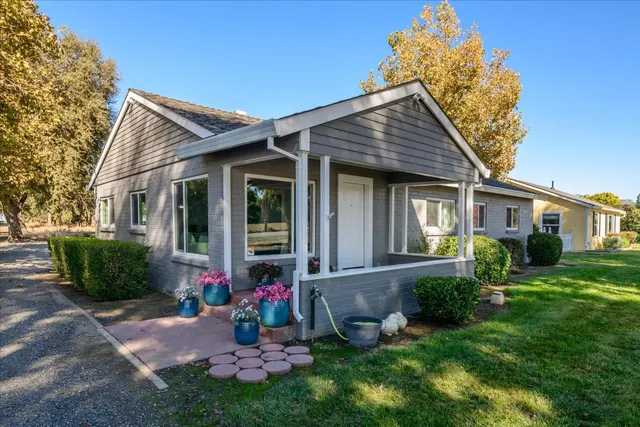a front view of a house with a yard and porch