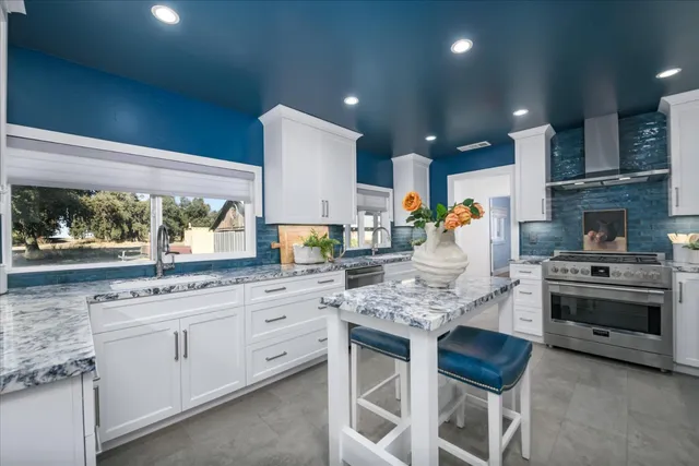 a kitchen with white cabinets and appliances
