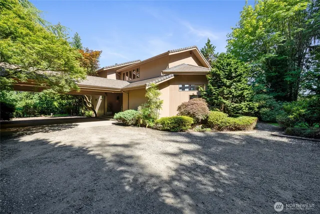 a front view of a house with a yard and a garage