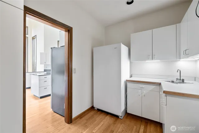 a kitchen with a refrigerator sink and cabinets