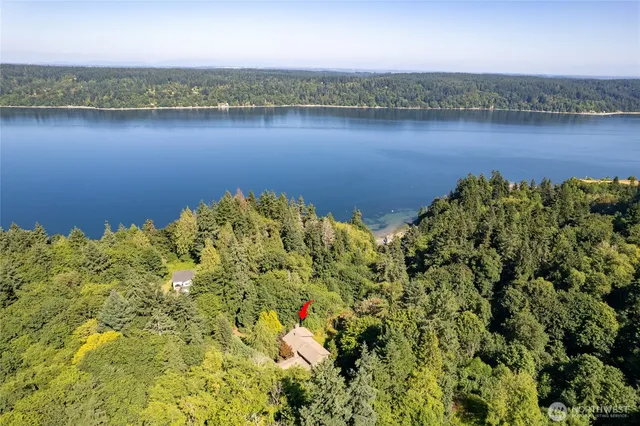 an aerial view of a houses with a lake view