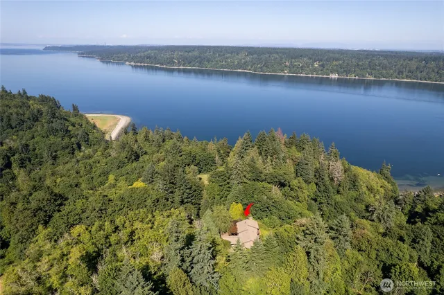 an aerial view of a houses with ocean view