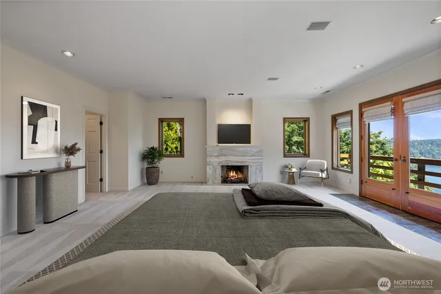 a living room with furniture a large window and a fireplace