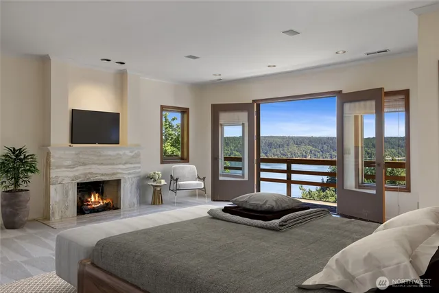 a bedroom with a balcony a bed and a fireplace