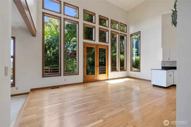 a view of an empty room with a window and balcony