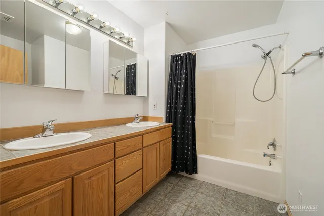 a bathroom with a tub sink and mirror