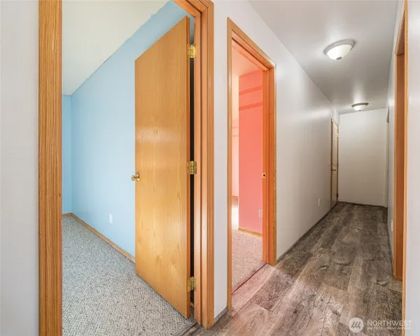 a view of a hallway with wooden floor