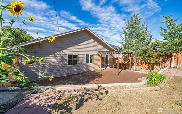 a front view of house with yard and trees around