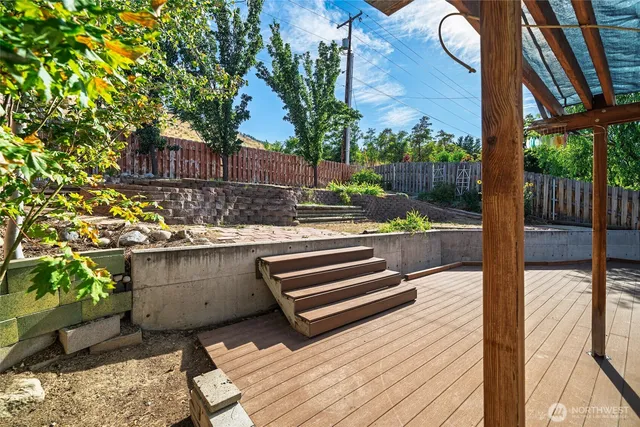 a view of a wooden bench next to a yard