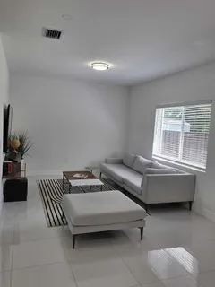 a living room with furniture and a window