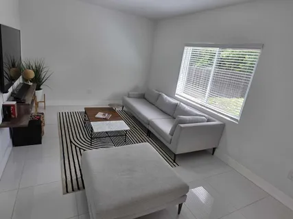 a living room with furniture and a window