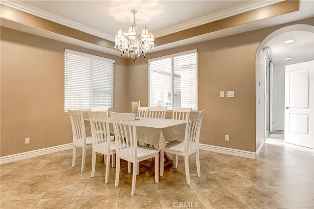 a view of a dining room with furniture and chandelier