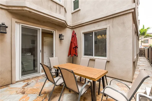 a view of a patio with table and chairs and potted plants