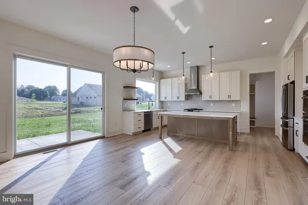 a open kitchen with stainless steel appliances granite countertop a stove and refrigerator