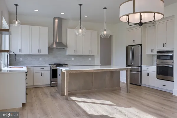 a kitchen with a refrigerator sink and cabinets