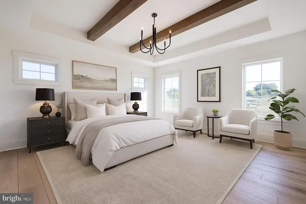 a bedroom with bed couch and window